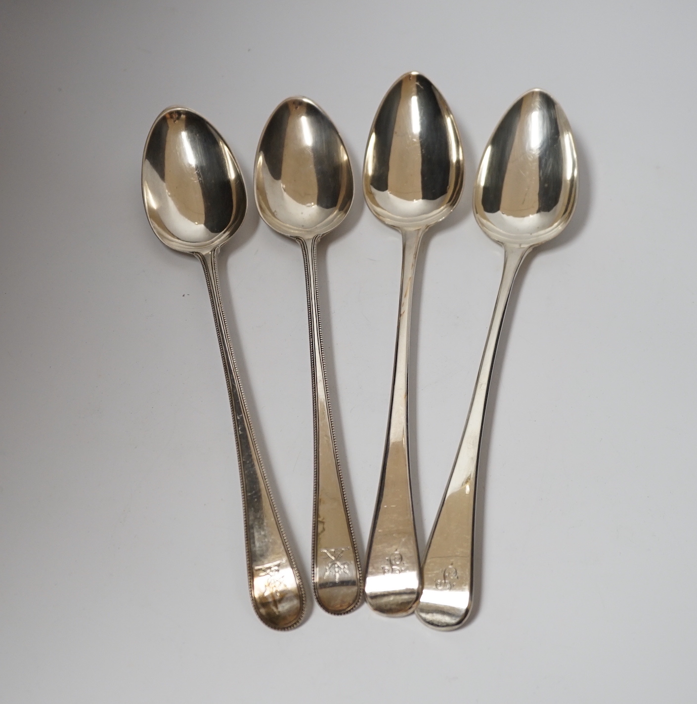 A pair of George III silver beaded Old English pattern basting spoons, George Smith III, London, 1785, 29.5cm and a later silver Old English pattern pair by Peter & William Bateman, 15oz.